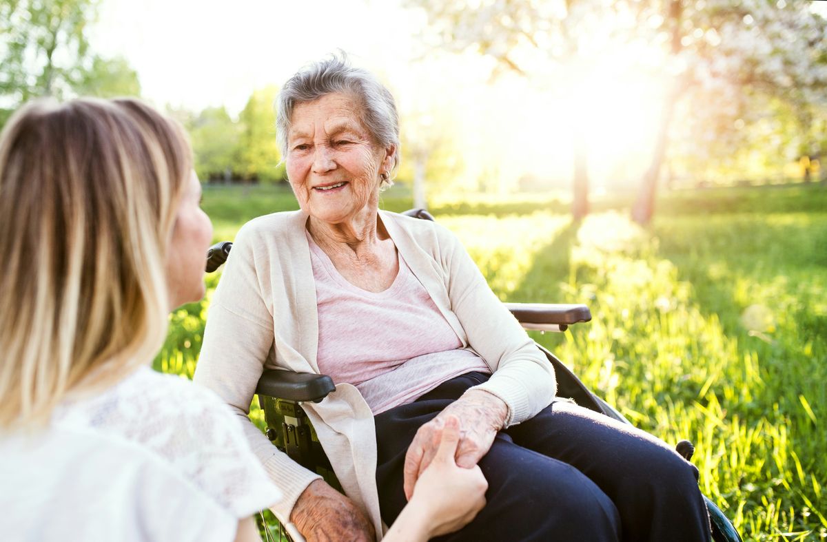 Elderly woman in sitting in the sun
