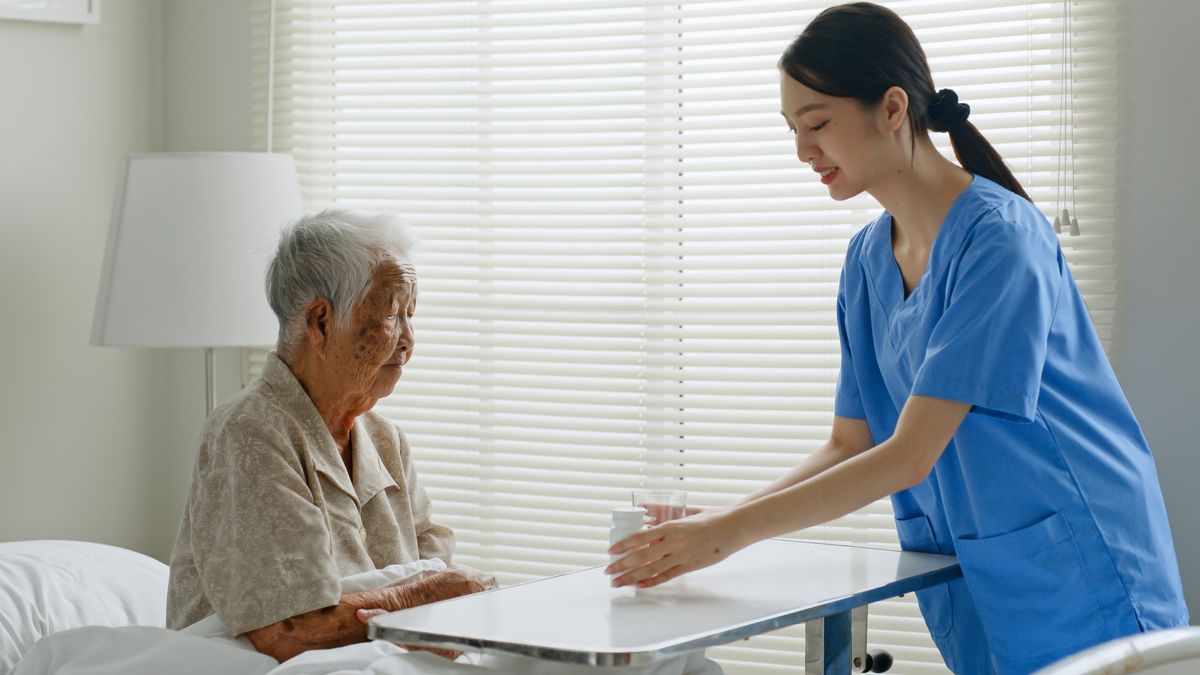A nurse assisting a senior of activities of daily living