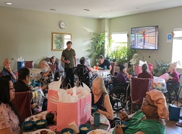 Residents and staff sharing a festive meal together